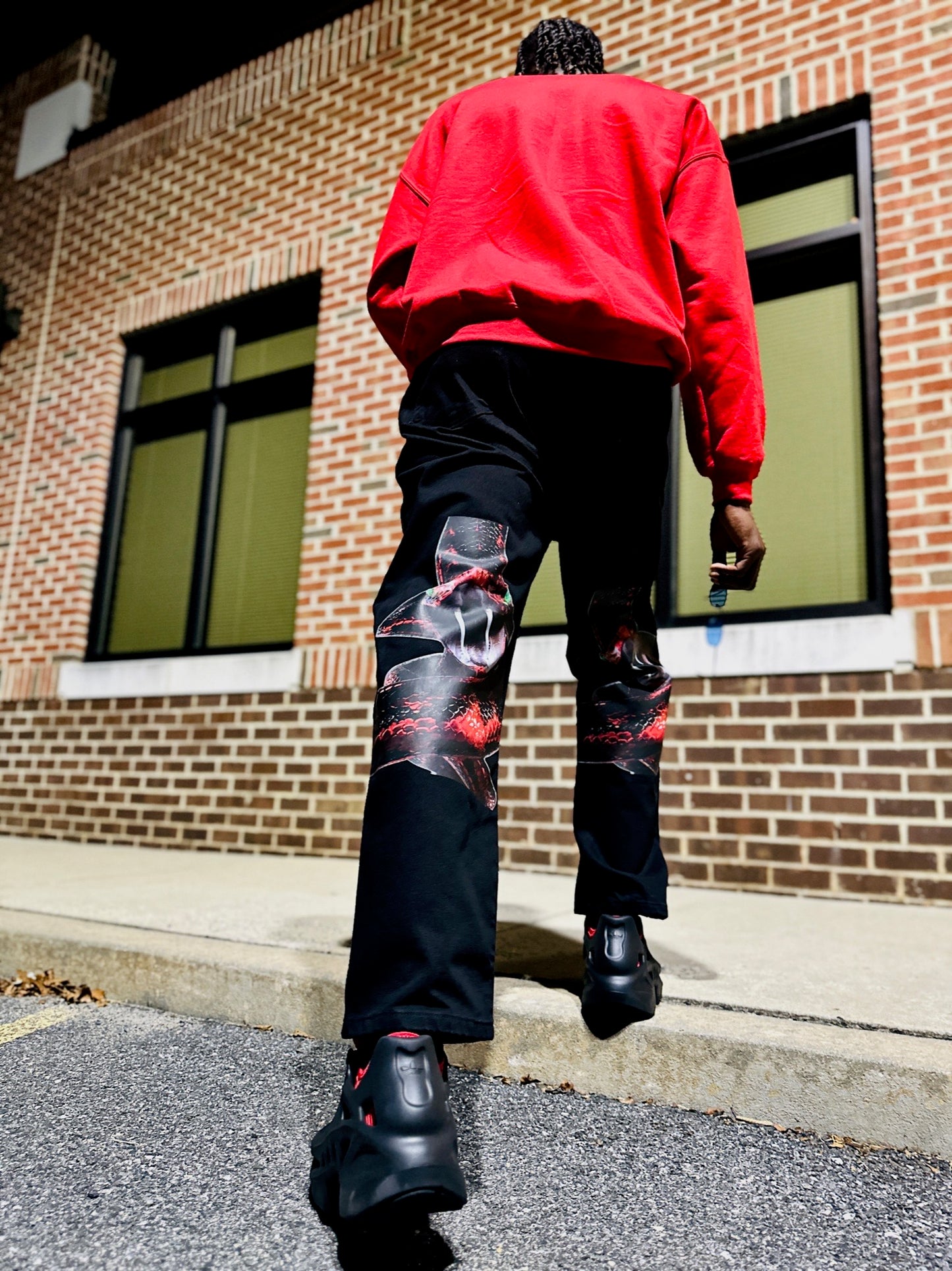 Myre black jean pant design “ coiled red snake”